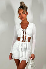 white mini skirt and long sleeve frilly tie front crop top festival clothes uk