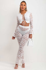 white  lace skinny flare trousers and bell sleeve lace up front going out crop top summer holiday festival rave outfit