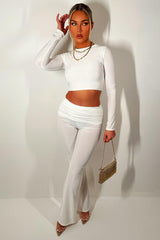 slinky double lined fold over waist flared leg trousers and long sleeve crop top two piece co ord set cream