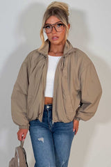 beige funnel neck jacket with cinched waist womens transitional autumn winter windbreaker jacket uk styledup
