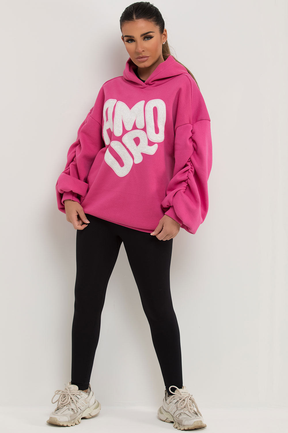 pink oversized hoodie with ruched sleeves and amour slogan