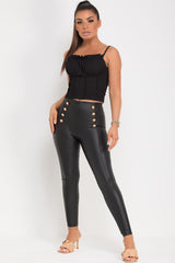 black high waisted faux leather leggings with gold buttons