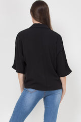 black oversized blouse with gold buttons and check pockets