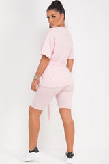 pink oversized top and cycling shorts set with utility belt