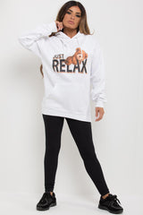 white oversized hoodie with teddy bear print and just relax slogan