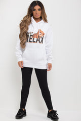 womens white oversized hooded sweatshirt with teddy print and just relax slogan